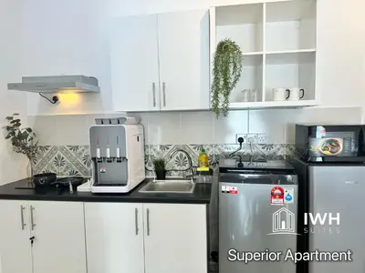 a white kitchen with a sink and a refrigerator at Ipoh Anderson Town Suites with 2 Parking by IWH in Ipoh