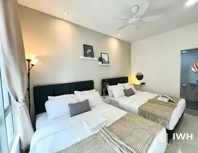 a bedroom with two beds and a ceiling fan at Ipoh Anderson Town Suites with 2 Parking by IWH in Ipoh