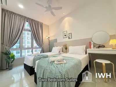 two beds in a room with two bedroom suites at Ipoh Anderson Town Suites with 2 Parking by IWH in Ipoh