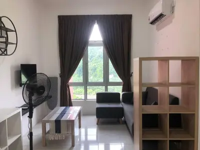 a living room with a bed and a window at Ipoh Anderson Suites by Migliore in Ipoh