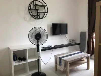 a white living room with a fan and a tv at Ipoh Anderson Suites by Migliore in Ipoh