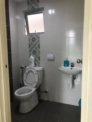 a bathroom with a toilet and a sink at Ipoh Anderson Suites by Migliore in Ipoh