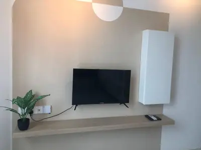a flat screen tv sitting on a wall at Ipoh Anderson Suites by Migliore in Ipoh