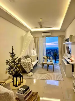 a living room with a christmas tree in the corner of a room at Blubelle Apt Near Lake Garden Zoo With Wifi Netflix in Taiping