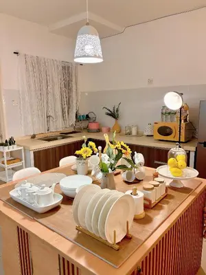 a kitchen with a table with plates and dishes on it at Blubelle Apt Near Lake Garden Zoo With Wifi Netflix in Taiping
