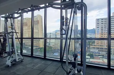 a gym with two exercise bikes in front of a window at Aesthetic Urban Suite With Infinite Pool & Gym in Jelutong