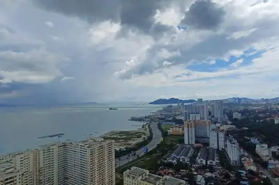 an aerial view of a city and a body of water at Aesthetic Urban Suite With Infinite Pool & Gym in Jelutong