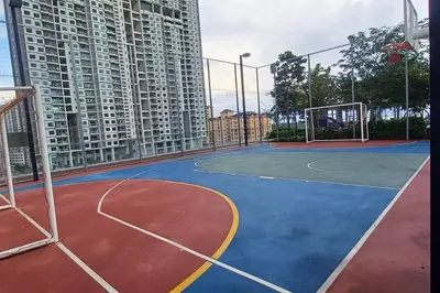 a basketball court in front of a tall building at Aesthetic Urban Suite With Infinite Pool & Gym in Jelutong