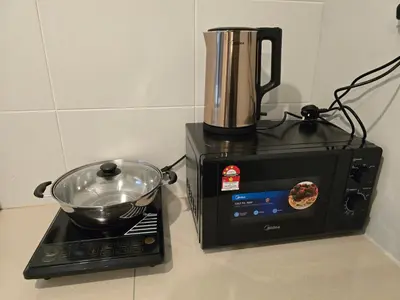 a blender sitting on a counter next to a microwave at Manhattan Condominium - Jalan Pasir Puteh - Ipoh in Ipoh