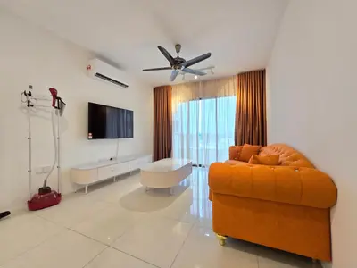 a living room with an orange couch and a flat screen tv at Manhattan Condominium - Jalan Pasir Puteh - Ipoh in Ipoh