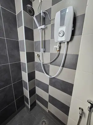 a shower in a bathroom with black and white tiles at Manhattan Condominium - Jalan Pasir Puteh - Ipoh in Ipoh