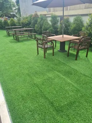 a group of picnic tables and benches with an umbrella at UniVilla- Ideal Family Home for 18pax in Gelugor