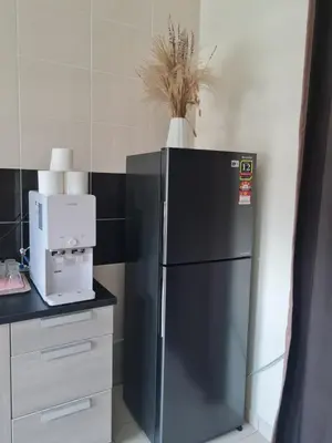 a kitchen with a black refrigerator and a coffee maker at UniVilla- Ideal Family Home for 18pax in Gelugor