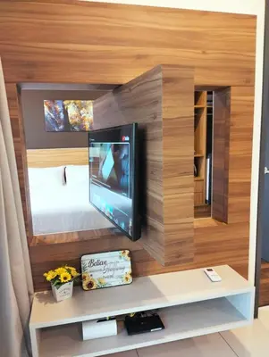 a small room with a tv and a bed at Lost World of Tambun, Sunway Onsen Studio, 1BR, 2-4pax in Tambun