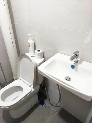 a bathroom with a white toilet and a sink at OV06-3room Georgetown Seaview Pg in George Town