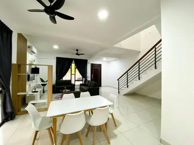 a dining room with a white table and white chairs at BrandNew Modern Cozy House@ALMA NEAR JUSCO in Bukit Mertajam