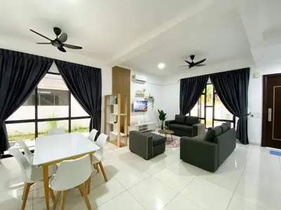 a living room with a couch and a table and chairs at BrandNew Modern Cozy House@ALMA NEAR JUSCO in Bukit Mertajam