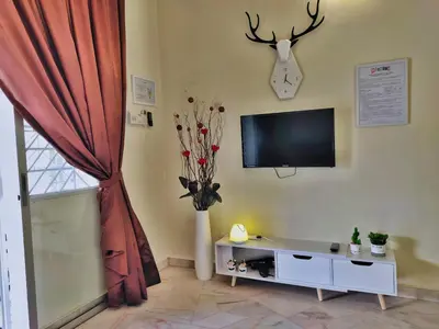 a living room with a flat screen tv on the wall at Queensbay Mall, Up to 5 Pax, 2 Bedrooms, 1 Bathroom, 1 Car Park by Star Home in Bayan Lepas