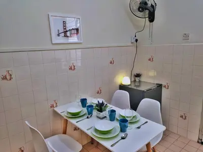 a white table with white chairs and plates on it at Queensbay Mall, Up to 5 Pax, 2 Bedrooms, 1 Bathroom, 1 Car Park by Star Home in Bayan Lepas