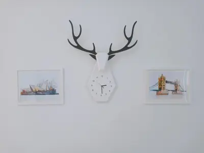 a clock with a deer head and antlers on a wall at Georgetown, Up to 5 Pax, 2 Bedrooms, 1 Bathroom, 1 Car Park by Star Home in George Town