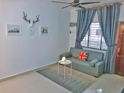 a living room with a couch and a window at Georgetown, Up to 5 Pax, 2 Bedrooms, 1 Bathroom, 1 Car Park by Star Home in George Town