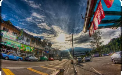 a city street with cars parked on the street at Hillside cottage tanah rata in Tanah Rata