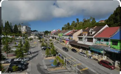 an aerial view of a town with cars parked on the street at Hillside cottage chalet studio in Tanah Rata