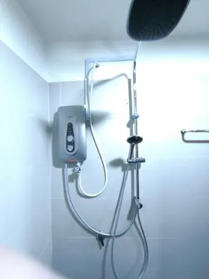 a shower in the corner of a bathroom at ZH Studio Apartment Gua Musang With WIFI dan POOL in Gua Musang
