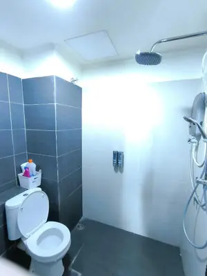 a bathroom with a white toilet and a shower at ZH Studio Apartment Gua Musang With WIFI dan POOL in Gua Musang