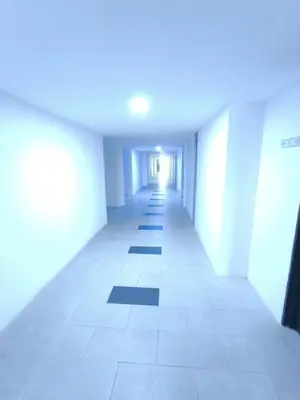 an empty hallway of an office building with white walls at ZH Studio Apartment Gua Musang With WIFI dan POOL in Gua Musang
