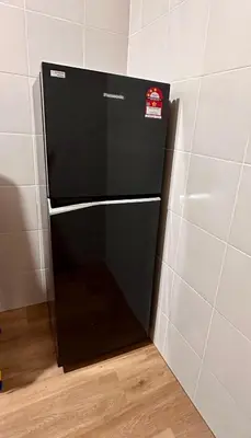 a black refrigerator in a corner of a room at Emerald Avenue Brinchang Muji style in Brinchang
