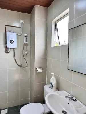 a bathroom with a sink and a toilet and a mirror at Emerald Avenue Brinchang Muji style in Brinchang