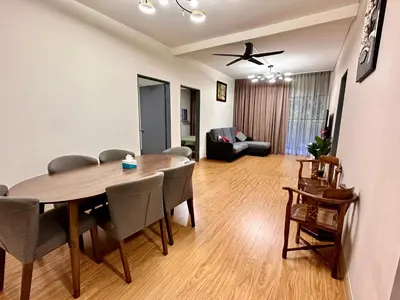 a living room with a dining room table and a couch at Emerald Avenue Brinchang Muji style in Brinchang