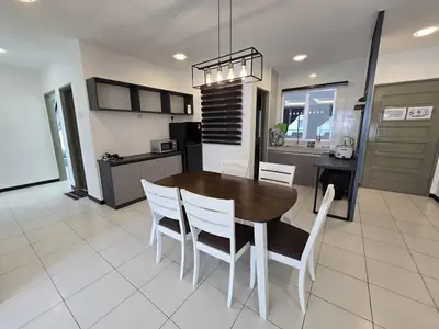 a kitchen and dining room with a table and chairs at D'Gaya Homestay Quintet Cameron Highlands in Tanah Rata