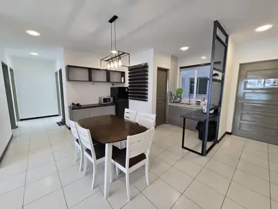 a kitchen and dining room with a table and chairs at D'Gaya Homestay Quintet Cameron Highlands in Tanah Rata
