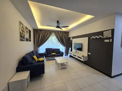 a living room with a blue couch and a tv at D'Gaya Homestay Quintet Cameron Highlands in Tanah Rata