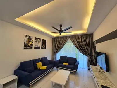 a living room with a blue couch and a tv at D'Gaya Homestay Quintet Cameron Highlands in Tanah Rata