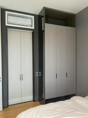 a bedroom with two closets and a bed at Luxury Seaview Private Elevator Near Island Hospital and Gurney plaza \u68b9\u57ce\u65e0\u654c\u6d77\u666f\u79c1\u4eba\u7535\u68af\u9760\u8fd1\u533b\u9662\u548c\u5546\u573a in Tanjong Tokong