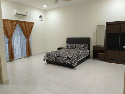 a bedroom with a bed and a tv in it at Homestay Sitiawan 53 in Sitiawan