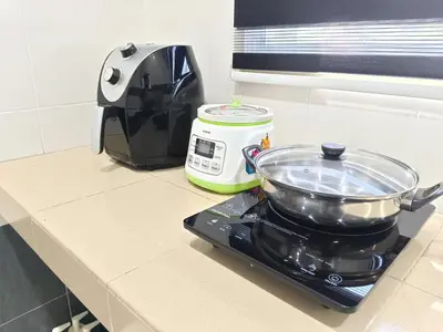 a kitchen counter with a pot on top of a toaster at Homestay Sitiawan 53 in Sitiawan