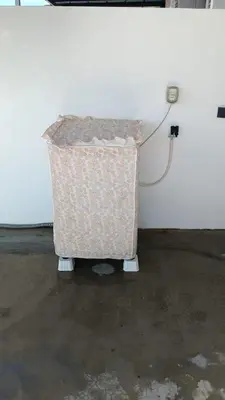 a trash can sitting next to a wall at Homestay Sitiawan 53 in Sitiawan