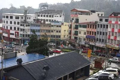 a city with a lot of buildings and cars on a street at Hotel Sentosa in Brinchang