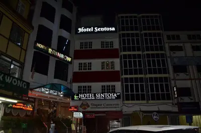 a building with signs on it on a city street at Hotel Sentosa in Brinchang