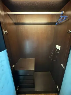 a shower in a room with a wooden wall at 2Beds Seaview Waterfront Straits Quay w/Free Carpark And Bathub in Tanjong Tokong