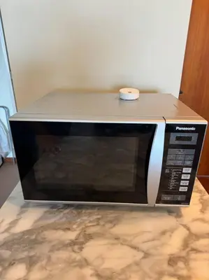 a microwave oven sitting on top of a counter at 2Beds Seaview Waterfront Straits Quay w/Free Carpark And Bathub in Tanjong Tokong