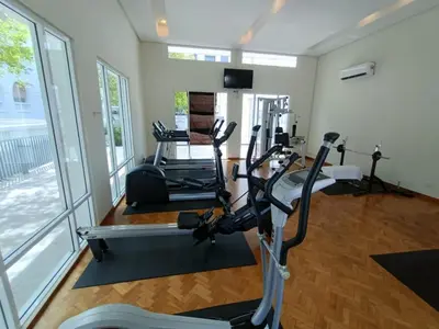 a gym with several treadmills and elliptical machines at 2Beds Seaview Waterfront Straits Quay w/Free Carpark And Bathub in Tanjong Tokong
