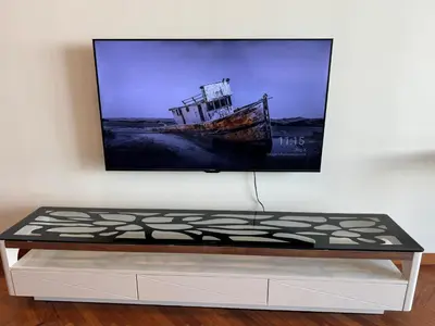 a tv hanging on a wall with a bed at 2Beds Seaview Waterfront Straits Quay w/Free Carpark And Bathub in Tanjong Tokong