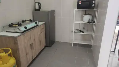 a kitchen with a sink and a refrigerator at Aufa Homestay 2 at Emerald Avenue Brinchang in Brinchang