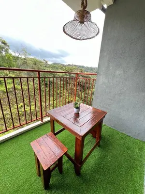 a wooden table and bench on a balcony at Aufa Homestay 2 at Emerald Avenue Brinchang in Brinchang