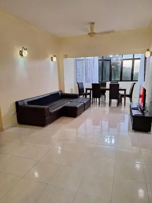a large living room with a couch and a table at Seaput Srisayang in Batu Ferringhi